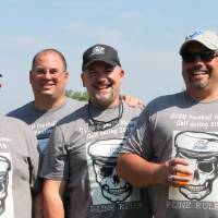 4 men in grey tshirts from event